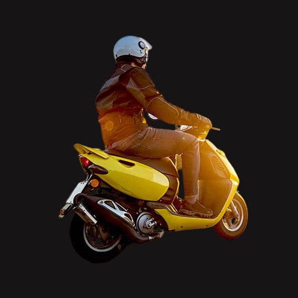 Person riding a yellow scooter on a road with a scenic background